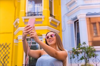 Portrait attractive young blonde woman taking a selfie