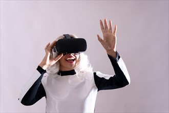 Close-up of adult woman gesturing with virtual reality goggles