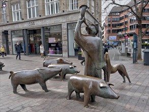 Group of bronze figures of a pig herder and his herd in Bremen-Mitte in Soegestrasse