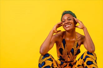 One black ethnic woman in traditional costume on yellow background