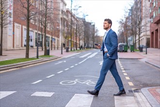 Businessman or finance man crossing a zebra crossing heading to the office