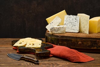 Assortment of different types of cheese on wooden block