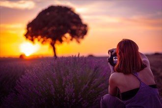 A woman at sunset in a lavender field with purple flowers