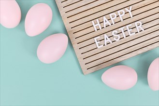 Happy Easter text on letter board with Easter eggs