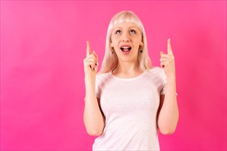 Blonde caucasian girl on pink studio background