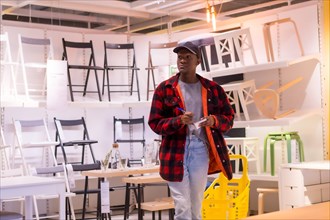 Black ethnic man shopping in a furniture store