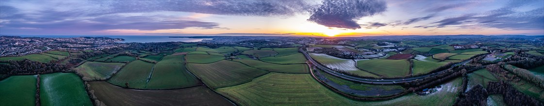 Panorama of Sunset over Fields and Farms shrouded in frost from a drone