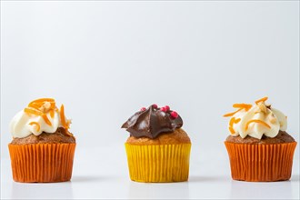 Assortment of chocolate and cream and carrot cupcakes