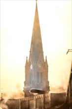 Church tower in fog at sunrise