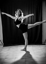 Young dancer in studio photo session with a black background