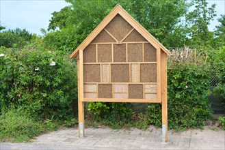 Big wood insect house hotel structure created to provide shelter for insects like bees to prevent extinction