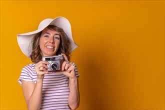 Caucasian girl in tourist concept with a photo camera in her hand and enjoying summer vacations