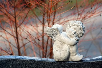 Angel figure sitting on a gravestone