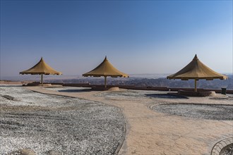 Giant umbrellas at an overlook over Al Ula