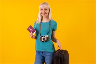 Smiling tourist with suitcase and passport