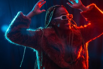 African young woman with braids with blue and red led lights