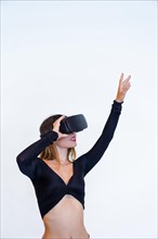 Woman wearing virtual reality goggles on white background