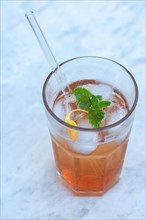 Glass with quince juice and a glass straw