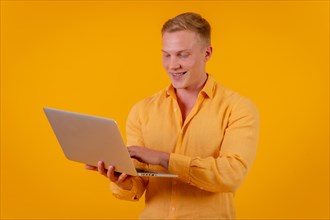 Caucasian blond businessman man on a yellow background