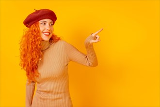 Red-haired woman in a red beret on a yellow background