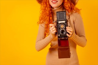 Unrecognizable redhead on a yellow background