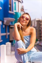 Portrait of attractive young blonde woman wearing sunglasses
