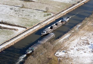 Aerial view of two barges in the Elbe Luebeck Canal in winter