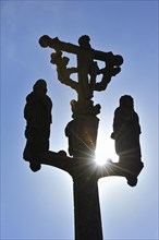 Silhouetted calvary at Saint-Meen