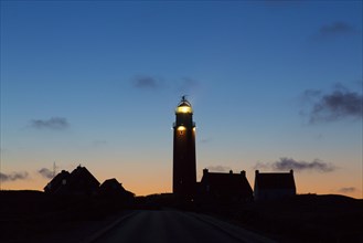Eierland Lighthouse in the dunes silhouetted against sunset on the northernmost tip of the Dutch island of Texel