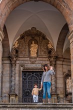 Mother and son tourists at the door of the Sanctuary of Loyola