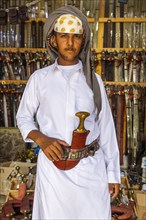 Traditional dressed man in a Store for daqggers or Jambiya
