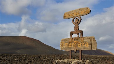 Wooden sculpture and sign at the entrance of the national park