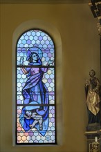 Coloured stained glass window with figures of saints in the Church of Our Lady Mariae Namen
