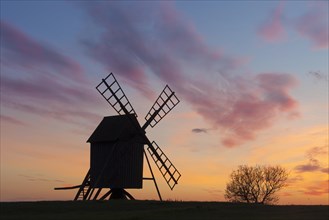 Traditional windmill at Resmo silhouetted against sunset on the island Oeland