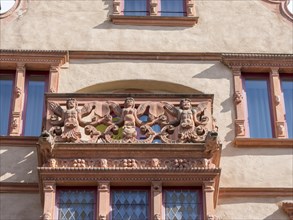 Ornamental human figures above the windows of a medieval building La Maison des Tetes in Rue des Tetes