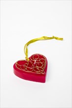 Red candle in heart shape with pendant