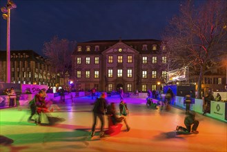 Ice skating rink in colourful evening lighting