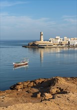 Fishing boat and Al-Ayjah Lighthouse