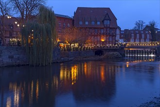 Christmas market in evening illumination at the former harbour on the Ilmenau