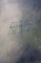 High-voltage pylon in the fog