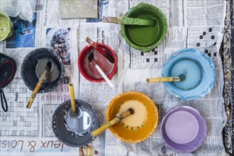 Small containers with colorful paints used to decorate ceramics in pottery factory in Fez