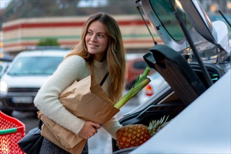 Woman with purchase from supermarket in parking lot