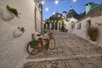 Trulli with bicycle at blue hour