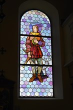 Coloured church window with St. Hubertus n the church of Our Lady Mariae Namen