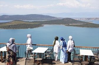 Turkish woman in headscarves look from Satan's Table at Ayvalik Islands National Park in the Aegean Sea