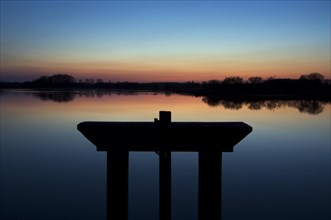 Sunset and traditional wooden sluice