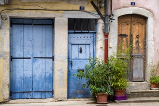 Coloured house facades and entrance doors in the southern French town of Ganges