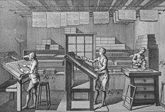 18th century typesetters arranging types called typesetting for letterpress printing in print shop