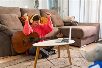 Woman learning to play the guitar at home
