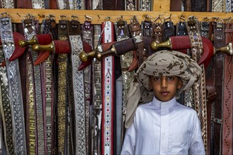 Traditional dressed boy in a Store for daqggers or Jambiya